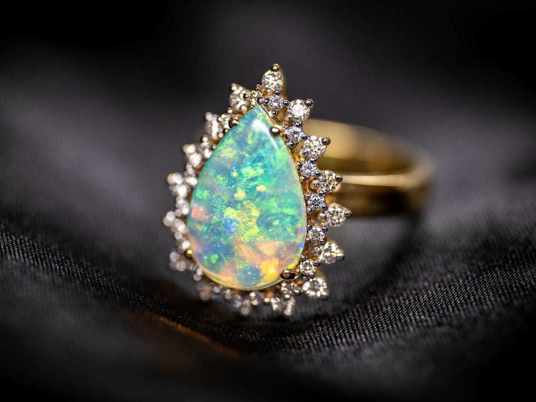 Gold and opal ring with diamonds around the edge